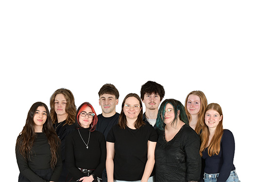 Group of nine young adults standing close together wearing casual dark clothing against a white background.