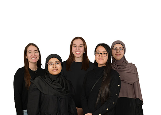 Portrait of five smiling women standing together against a white background.